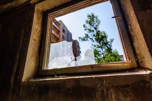 istock Broken glass in window in abandoned building in ghost town Pripyat Chornobyl Zone 1275860906