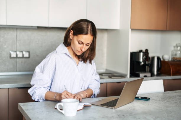 istock Young woman works from home with a laptop 1275863540