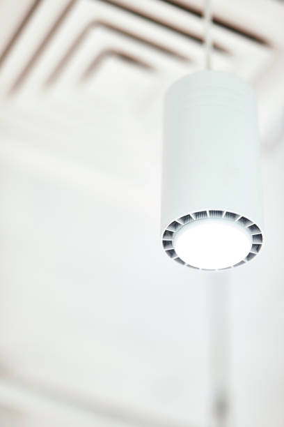 istock Pendant light. Close up of a modern white ceiling lamp shaped tube 1275863718