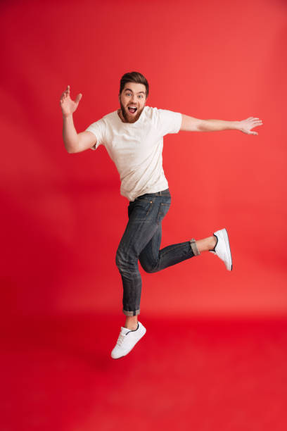 istock Excited emotional bearded man jumping 1275866435