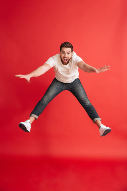 istock Excited emotional bearded man jumping 1275867098