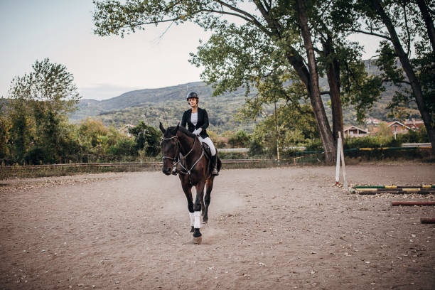 istock Female jockey riding a horse 1275867607