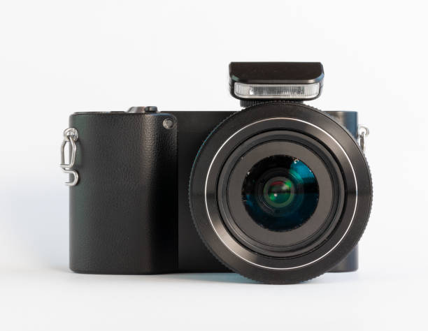 istock Used and dirty photo camera with flash integrated on a white surface 1275867637