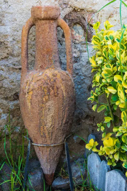 Ancient Mediterranean amphora in a garden. Spain