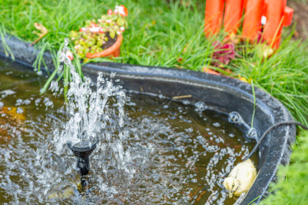 istock Small decorative fountain in a green garden 1275868456