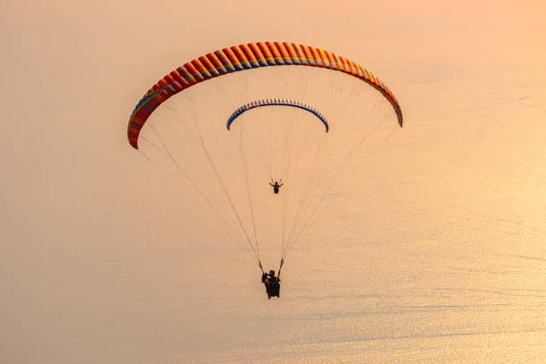 istock Sunset landscape with paragliding in the sky 1275871598