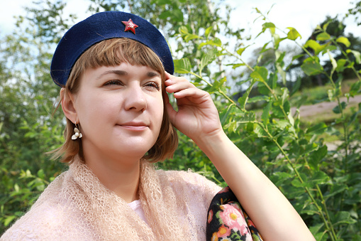 Woman in Soviet military beret in tpark