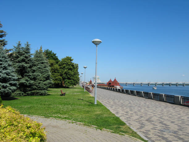 istock river embankment with parkland, lanterns and evergreen trees 1275872925