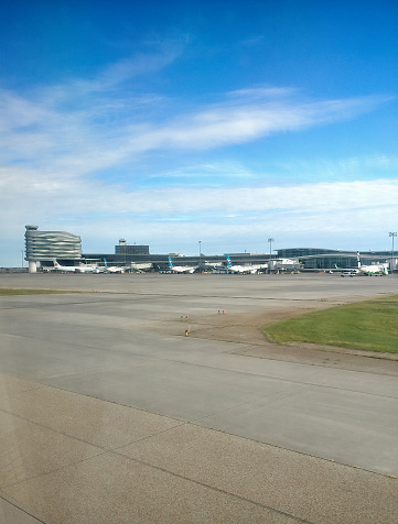 Airplanes are parked at Edmonton International Airport in Edmonton, Alberta, Canada on a sunny day.