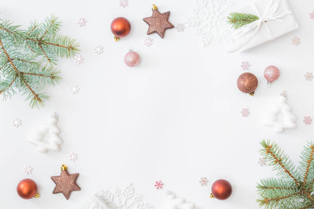 istock Flat lay frame with fir branches, christmas baubles decoration and gift box on a white background 1275877223
