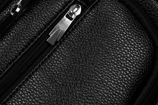 zipped pocket on leather surface