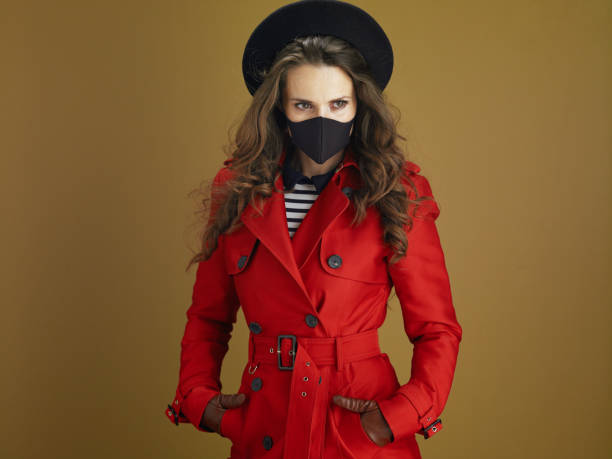 istock modern female in red coat against bronze background 1275879116