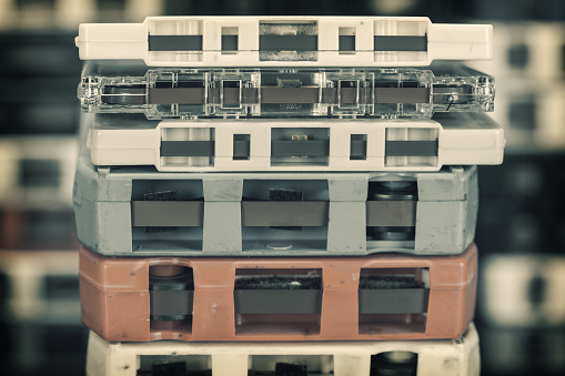 Stacks of 8-track and cassette music tapes.