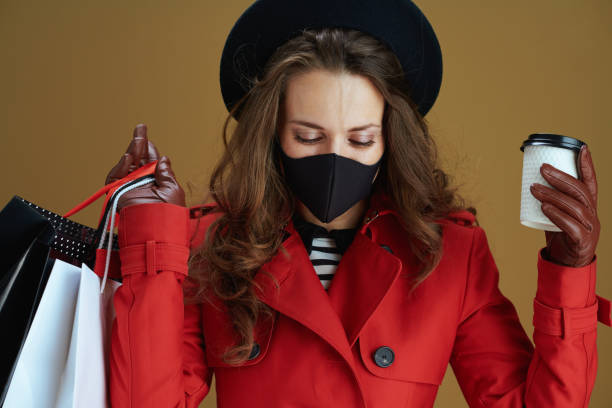 istock stylish woman in coat isolated on beige background 1275879367