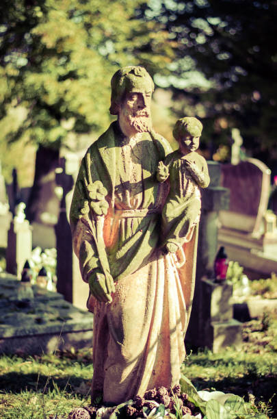 istock statue of saint holding little child on hands 1275880576