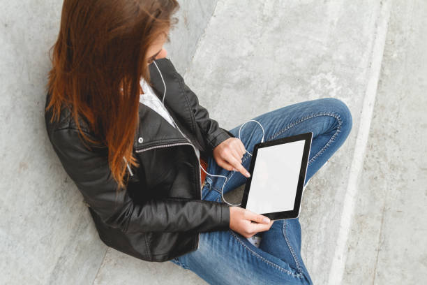 istock Girl with a tablet in hands 1275883652