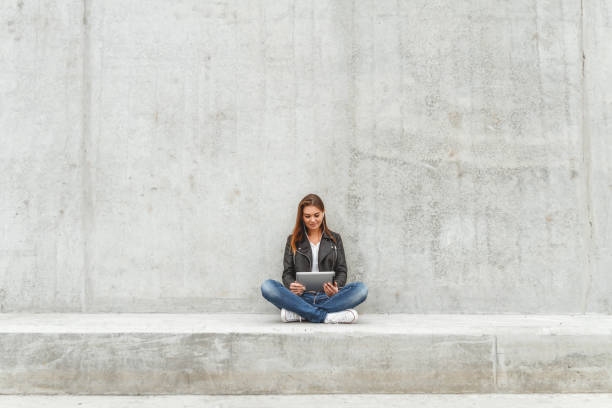 istock Girl with a tablet in hands 1275883701
