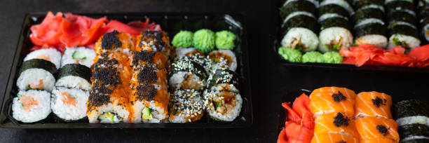 istock sushi rolls salmon fish flying fish roe vegetables ginger wasabi rice and nori on the table top view place copy space for text food background rustic 1275885105