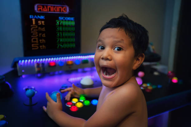 First place ranking or high score by a young gamer with an enthusiastic expression while gaming on a home arcade. stock photo