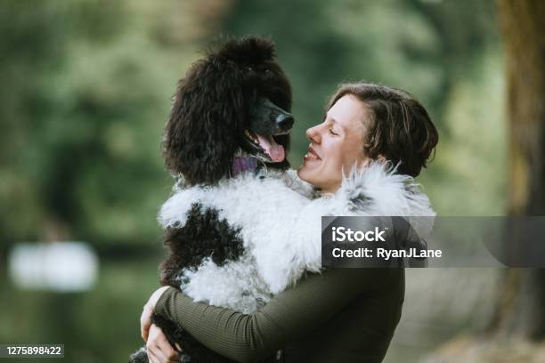 Young Woman Spending Quality Time With Her Dog Outside Stock Photo - Download Image Now