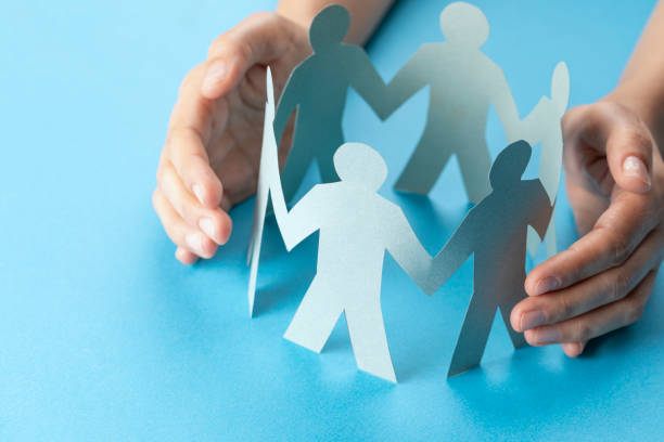 istock Hand Protecting Paper Cut Out Figure 1275922588