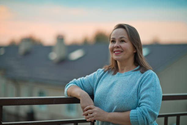 istock Mature woman looking optimistic on the future over evening sky 1275922617
