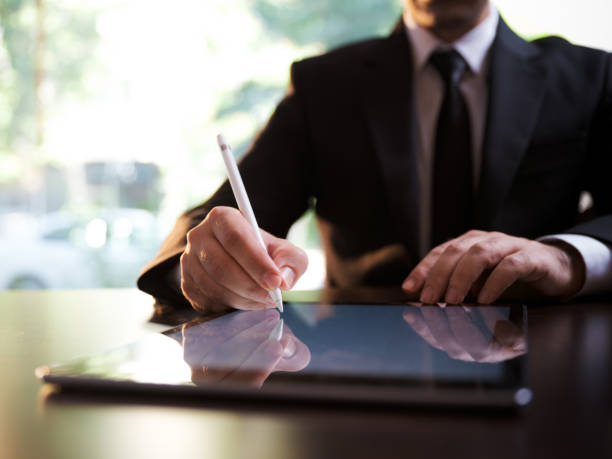 istock Businessman Signing Digital Contract On Tablet Using Stylus Pen 1275935147