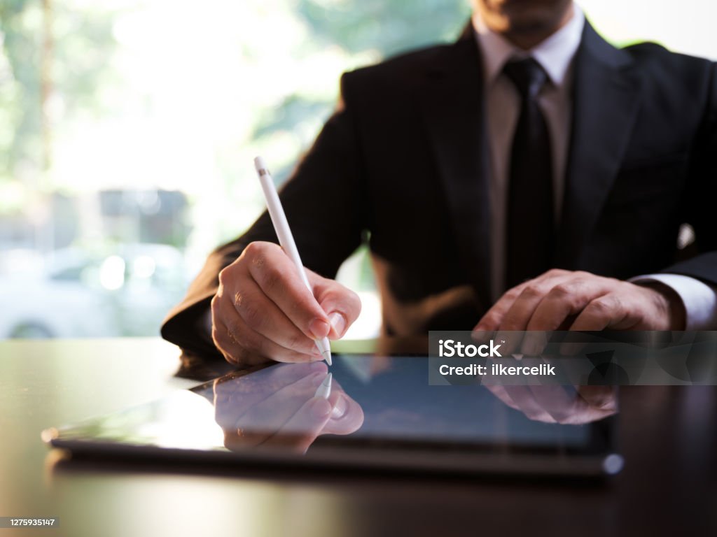 Businessman Signing Digital Contract On Tablet Using Stylus Pen Contract Stock Photo