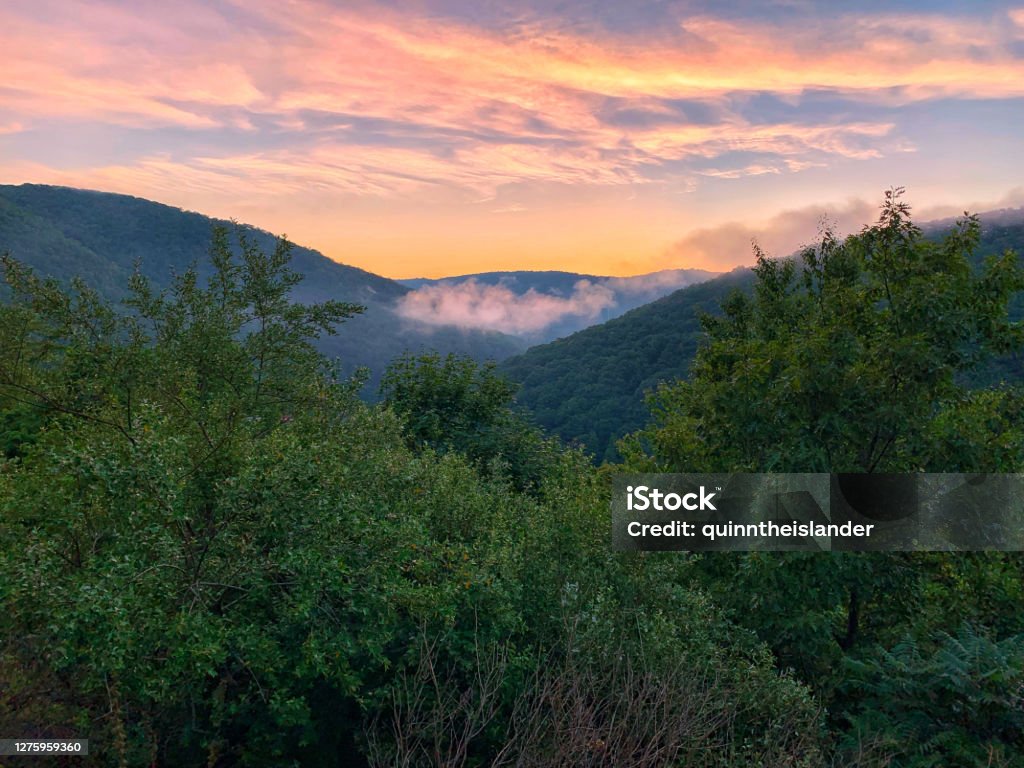 Above the Poconos at Sunset A colorful sunset sky above the cool, cloudy Pocono Mountains in Pennsylvania Pocono Mountains Region Stock Photo