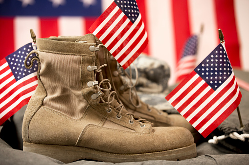 American Flags, military boots, dog tags and hat.  Remembering on Veteran's Day and Memorial Day.