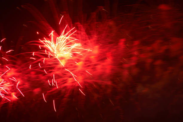 Red fireworks and smog, black night sky background