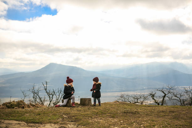 istock girls in mountains playing - rock, scissors, paper 1275996169