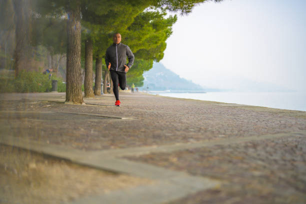 istock Jogger running on the coast next to the sea 1276017210