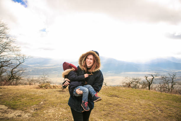 istock mom plays with kid in mountains at winter camp 1276020235