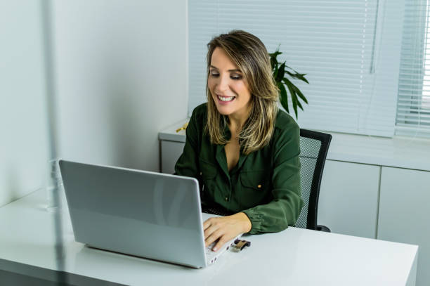 istock a woman in the office, doing online service 1276020543