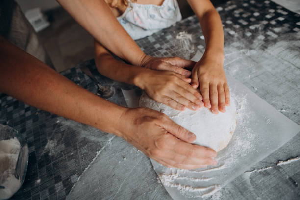 istock homemade bread cooking hands mom daughter together 1276030595