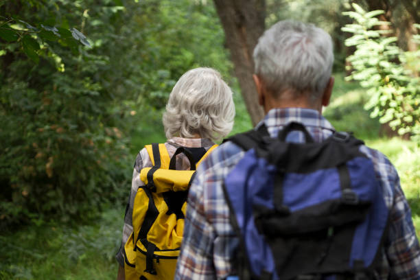 istock Senior couple hiking through the forest exploring nature ,rear view 1276034109