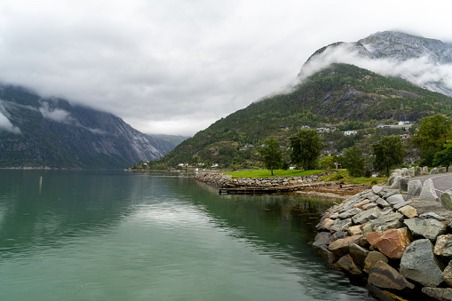Eidfjord, a Norwegian town and municipality in the Hordaland region, view from the beach on the Eid fjord, the inner branch of the large Hardangerfjorden in Scandinavia