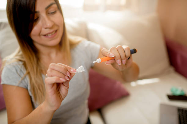 istock Young diabetic women holding  insulin pen 1276047279