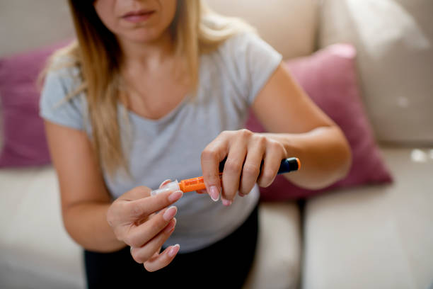 istock Young diabetic women with insulin pen 1276069204