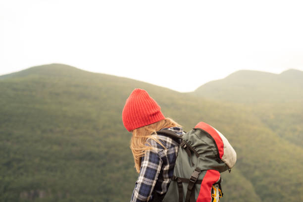 istock Young woman hiking in mountains 1276093414