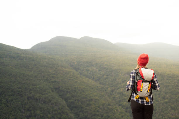 istock Young woman hiking in mountains 1276093946