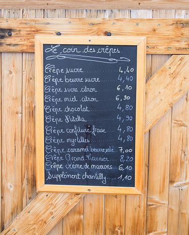 Crepes menu handwritten on blackboard outside a french restaurant