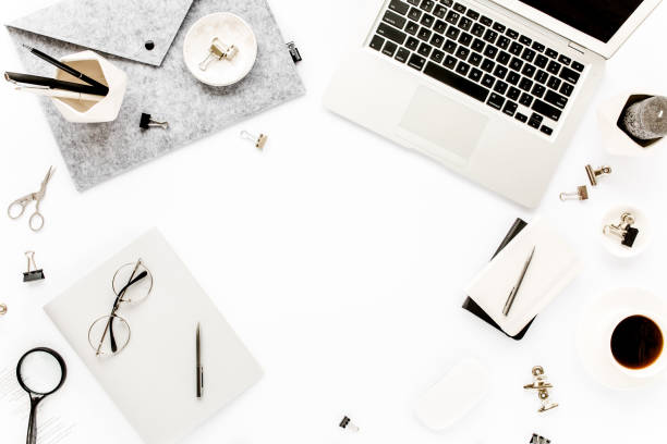 istock Home office workspace frame with laptop, clipboard, notebook and accessories on white background. Flat lay, top view 1276117204