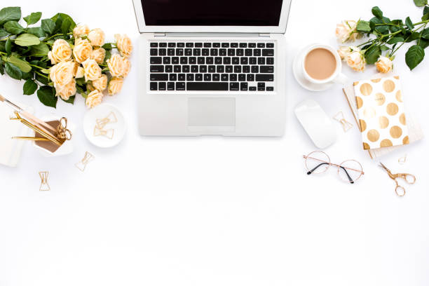 istock Female workspace with laptop, roses flowers, golden accessories, diary, computer, glasses on white background. Flat lay women's office desk. Top view 1276117217