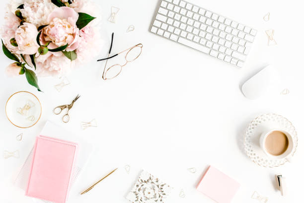 istock Flat lay women's office desk. Female workspace with computer, pink peonies bouquet, accessories on white background. Top view feminine background 1276148115