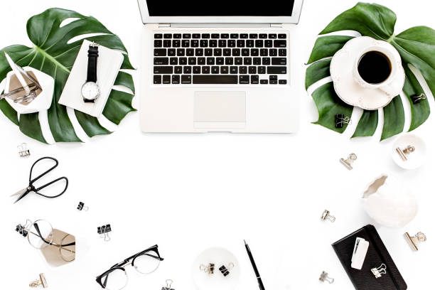 istock Home office workspace mockup with laptop, tropical leaves Monstera, clipboard, notebook and accessories on white background. Flat lay, top view 1276148914