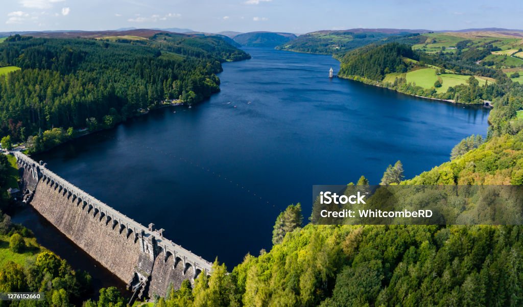 Aerial view of a huge lake surrounded by rural farmland and forest. (Lake Vyrnwy, Wales) Reservoir Stock Photo