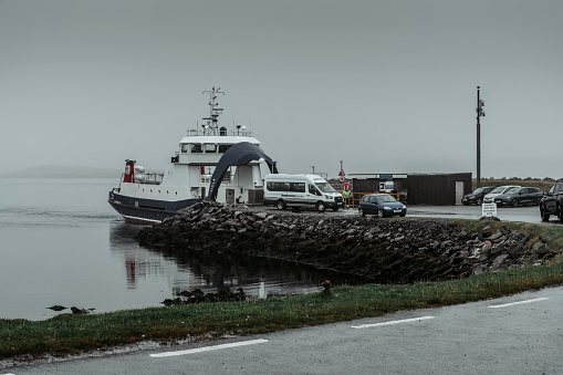 MV Fivla, a roll-on / roll-off car ferry, disembarks cars after arrival at Gutcher on the island of Yell in Shetland, Scotland,