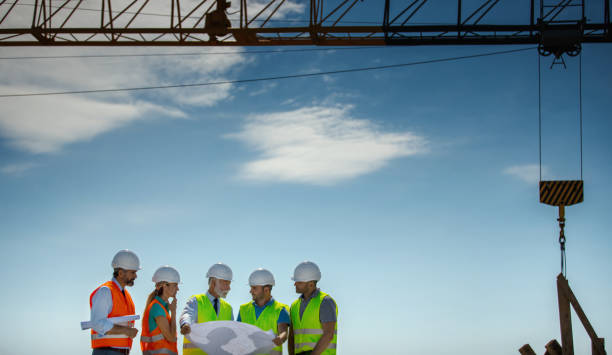 istock Group of contractors supervising building process on a rooftop. 1276173693